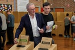 Australian Prime Minister Anthony Albanese and his son Nathan place their votes in a ballot box at a polling booth in his electorate in Sydney on Saturday.