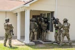 Immigration and Customs Enforcement (ICE) Special Response Team members demonstrate how the team enters a residence in the pursuit of a wanted subject at the Federal Law Enforcement Training Centers (FLETC) in Brunswick, Ga. on Thursday, Aug. 21, 2025.
