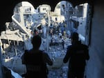 Palestinians inspect their destroyed homes following Israeli bombardment in Rafah in the southern Gaza Strip, on Wednesday, Oct. 18, amid ongoing battles between Israel and the Palestinian group Hamas.