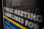 FILE — The Portland Public Schools Board of Education members are reflected in a sign during a meeting announcing the district’s 2026-2027 budget at Dr. Matthew Prophet Education Center in Portland, Ore., on April 28, 2026. This is the 3rd year of budget cuts to PPS in a row.