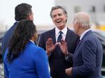 California Gov. Gavin Newsom talks with President Biden and other Democratic officials at San Francisco International Airport on Nov. 14, 2023.