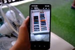A man who worked in scam compound in Cambodia shows the only evidence he managed to document on his phone, a photo of dozens of phones that he was given to reach out and recruit potential scam victims.