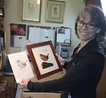 Scientific illustrator Nora Sherwood with her treatments of a Pacific wren.