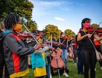 Violinists, violists and cellists of all ages came out to play improvised music at a vigil for Elijah McClain at Peninsula Park in Portland, Ore., Friday, July 3, 2020. 