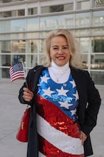 Karen Perez, who is from Venezuela, waves an American flag after the naturalization ceremony.