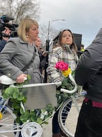 Jaime Bolognone prepare to take a ghost bike honoring her late fiancé, Gerardo Marciales, out into the intersection where he was recently killed.