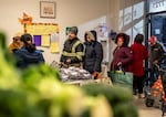 A group of people stand in line at the No Limits Food Pantry distribution.