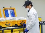 In this Saturday, March 28, 2020, file photo, a staffer works on a ventilator refurbishing assembly line at Bloom Energy in Sunnyvale, Calif. The COVID-19 outbreak has prompted companies large and small to rethink how they do business. Bloom Energy makes hydrogen fuel cells. But recently, they have been refurbishing old ventilators so hospitals can use them to keep coronavirus patients alive.