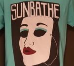 Portland band Sunbathe offers a t-shirt with a mask on it that, according to our expert, could be fashioned into a mask.