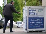 Jeremy Haug drops a ballot into the drop box at the Hillsdale Library in Hillsdale, May 21, 2024.