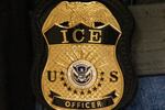 FILE - A federal agent wears an Immigration and Customs Enforcement badge in New York, June 10, 2025.