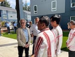 Oregon Gov. Tina Kotek, left, talks to representatives of Immigrant & Refugee Community Organization (IRCO) in Portland, Ore., at a press conference Monday, July 22, 2024, announcing a $200 million federal environmental grant awarded to the state.