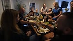 Misha Varvarych and his fiancé Ira Botvynska have dinner at a group home they share with other Ukrainian amputee soldiers and the volunteers assisting them for Revived Soldiers Ukraine in Orlando Florida