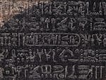 This picture taken on July 2022 shows a close-up view of the cartouche of the Ptolemaic dynasty Pharaoh Ptolemy V "Epiphanes" (210-180 BC) inscribed with the rest of the ancient Egyptian hieroglyphic text in the upper portion of the Rosetta Stone, on display at the British Museum in London.