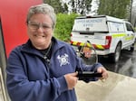 Christiana Rainbow Plews holds a commemorative plaque honoring her service as a fire chief, shortly after her retirement this year. She and her fellow firefighters battled the Holiday Farm Fire when it swept through Blue River on Labor Day, 2020.