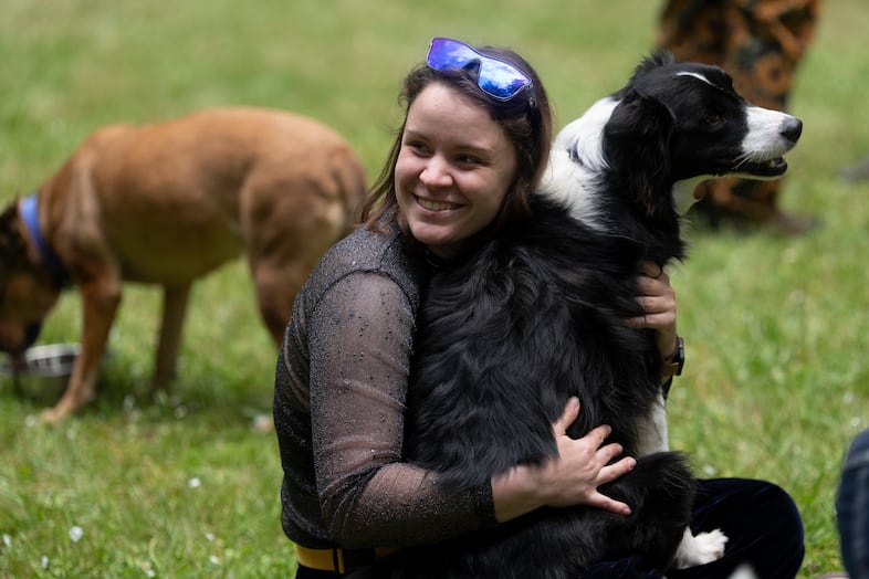Kora Wietrzynska holds her dog, Sable, while talking with other participants during the filming of the reality dating show "Fetching" on Sunday, June 7, 2026 in Hillsboro, Ore.