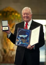 FILE - Former President Jimmy Carter receives the 2002 Nobel Peace Prize in Oslo City Hall in Oslo, Norway, Dec. 10, 2002.