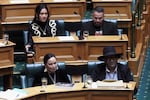 New Zealand lawmakers Hana-Rāwhiti Maipi-Clarke, top left, Debbie Ngarewa-Packer, bottom left, and Rawiri Waititi, bottom right, watch as other legislators debate their proposed bans in parliament in Wellington on Thursday, June 5, 2025.