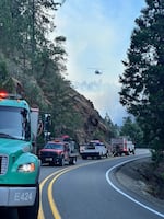 Firefighting vehicles line up on the road for addressing the Dixon Fire near Tiller, Oregon, in this undated supplied photo.