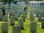 Every year, members from every branch of the military participate in placing flags on more than 400,000 tombstones on the cemetery grounds.