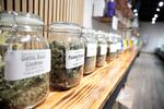 Jars of marijuana line a shelf at The Flower Shop Dispensary in Sioux Falls, S.D. on Oct. 14, 2022. South Dakota's legal pot industry has started with medical cannabis, but voters are deciding whether to also legalize recreational pot.