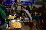 Volunteers with the Saylani Welfare International Trust charity distribute food to displaced people in an area hit by floods in Sukkur, Sindh province, on Aug 29.