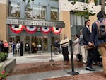 People line up outside the Oakland, California federal courthouse ahead of opening arguments in the trial that four state attorneys general are bringing against Meta Platforms, Inc.