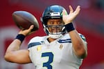 FILE - Seattle Seahawks quarterback Russell Wilson warms up prior to an NFL football game against the Arizona Cardinals in Jan. 9, 2022, in Glendale, Ariz.  Tension between Wilson and the Seahawks surfaced last offseason. Now the issue is what's best for the club's future, although the Seahawks keep saying they're not shopping the Super Bowl 48 winner.