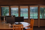 Football players practice is seen from the second story of Portland State University's library on Sept. 19, 2024, with a note reading "Gaza We Love You" written between the windows. The library recently reopened spending months repairing the impacts of a four-day protest.