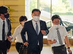 Japan's Chief Cabinet Secretary Hirokazu Matsuno, center, arrives at the prime minister's office in Tokyo on Tuesday.