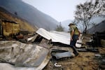 Dave Jeter, 78, walks through ash and debris July 29, 2026 in Huntington, Ore., after the Fox Fire destroys his home.
