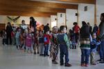 Young dancers in Warm Springs perform a mini powwow in the longhouse, as elder women in the adjoining room make preparations for root feast. March 12, 20212