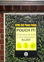 A sign in Harriet Tubman Middle School reminds students of their cell phone policy in Portland, Ore., Aug. 26, 2025. Students at the school put their phones in a locking Yondr pouch at the beginning of the school day.