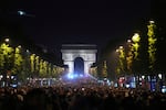 Soccer fans celebrate PSG's victory on the Champs-Elysees avenue, with the Arc de Triomphe in background, after the Champions League final soccer match between Paris Saint-Germain and Inter Milan, Sunday, June 1, 2025 in Paris.