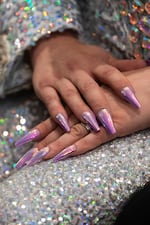 Onoscopi sports iridescent purple nail polish to compliment her rhinestone outfit.