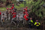 Search and recovery workers dig through debris looking for any survivors or remains of people swept up in the flash flooding at Camp Mystic near Hunt, Texas on Sunday.
