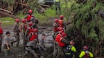 Search and recovery workers dig through debris looking for any survivors or remains of people swept up in the flash flooding at Camp Mystic near Hunt, Texas on Sunday.