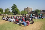 Detained Bangladeshi migrants sit at a crime branch office following an overnight operation by the state police in Ahmedabad, India, on April 26.
