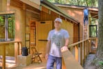 Friends of Tryon Creek executive director Gabe Sheoships poses for a portrait on Sept. 13, 2025, at the new education pavilion which was designed to evoke traditional plankhouses used by Indigenous Northwest tribes for potlatches, ceremonies and other events.