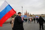 People approach screens located near the Kremlin and Red Square before the live broadcast of a ceremony to declare the annexation of the Russian-controlled territories of Ukraine's Donetsk, Luhansk, Kherson and Zaporizhzhia regions in Moscow on Friday. Russian authorities held referendums in the occupied areas of Ukraine that were condemned by Kyiv and governments worldwide.