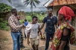 A man is lead away during a police crackdown in Waterloo, Sierra Leone. Police are attempting to enforce a "zero tolerance" policy on kush.