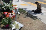 Nicole Witherow prays beside flowers placed outside the Islamic Center of San Diego on May 19.