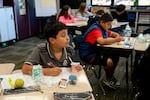 A fifth grade student looks up as he does classwork in teacher Julie Schaffner’s class at Wascher Elementary School in Lafayette, Ore., on Wednesday, Oct. 15, 2025.