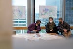 Lori Kelley of Multnomah County's Joint Office of Homeless Services, left, project manager Carolyn Niehaus and Jacob Grigor, both of HRAC, look over data at the command center. 