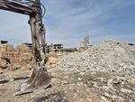 A backhoe was brought in to excavate mass graves in Jobar on March 26.