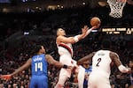 Portland Trail Blazers forward Toumani Camara (33) drives past Orlando Magic guard Gary Harris (14) to the basket during the second half of an NBA basketball game Thursday, Jan. 30, 2025, in Portland, Ore.