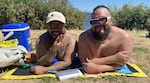 Derek Dizon, left, and Erik Rios, right, came to Denny Blaine Park in Seattle on July 15, 2025, to cool off and relax.