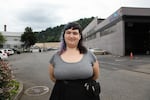 Carsen Harrison-Bower stands behind Amazon's Northwest Portland delivery station on July 17, 2019. She said, without air conditioning, it gets very warm in the summer.