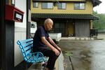 Toshiyuki Mimaki, 83, co-chair of Nihon Hidankyo, a Nobel Peace Prize-winning group of a-bomb survivors in Japan, sits outside his farmhouse, about 10 miles outside the city of Hiroshima.