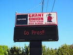 A sign reading "Grant Union Junior/Senior High school" stands against a blue sky. An electronic display reads, "Go Prospectors!"
